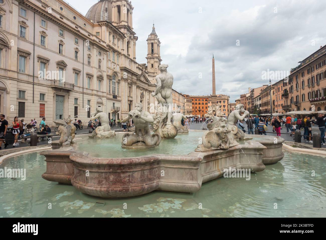 Rome, Italy - September 25, 2022 -  Tourists enjoying sightseeing in Piazza Navona next to a Baroque fountaint Stock Photo