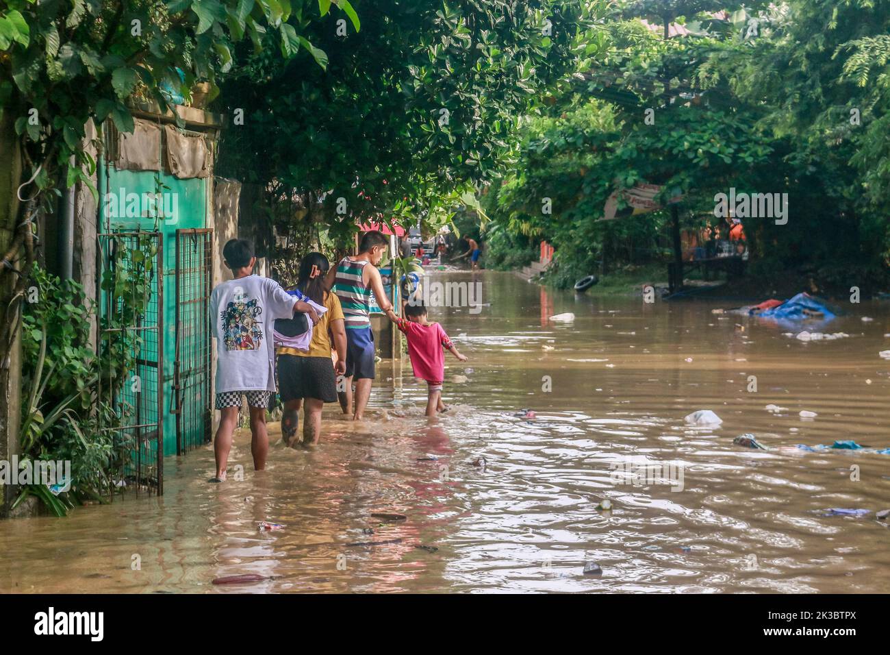 Marikina, Philippines. 26th Sep, 2022. Super typhoon victims walk on a flooded area to return on their properties after the raged of Noru. Super Typhoon Noru locally named as Karding battered in the landmass of Luzon island in the Philippines. Noru with the wind of 140 kilometers per hour near the center and gustiness of up to 170 km per hour forcing the evacuation of thousands of individuals specially in hardly hit and catch basin areas. (Photo by Ryan Eduard Benaid/SOPA Images/Sipa USA) Credit: Sipa USA/Alamy Live News Stock Photo