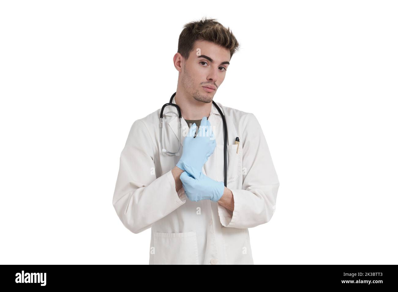 Young caucasian male doctor wearing blue gloves looking at camera, isolated. Stock Photo