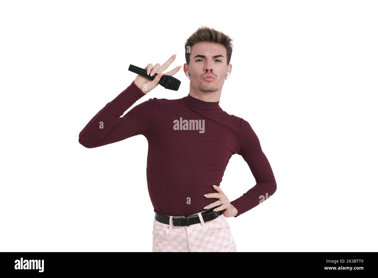 Young caucasian man posing with a microphone, isolated. Stock Photo