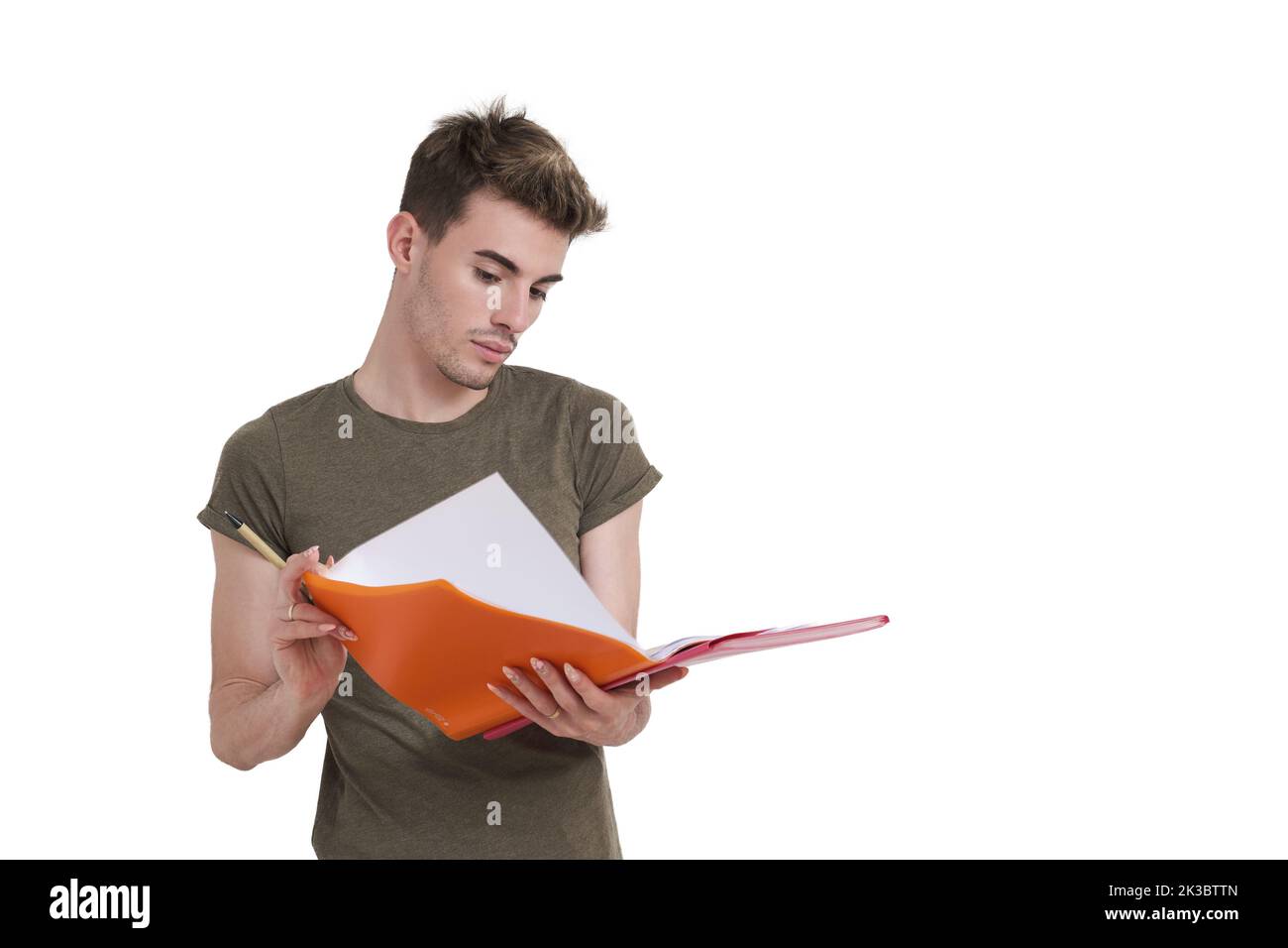 Young caucasian student reading notes on a folder, isolated. Stock Photo