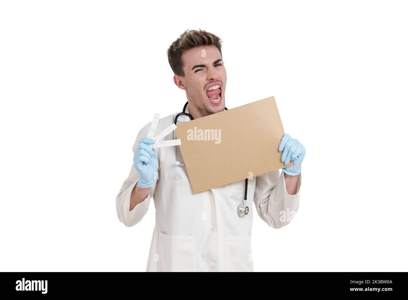 Young doctor shouting with a board and negative covid-19 antigen test, isolated. Stock Photo