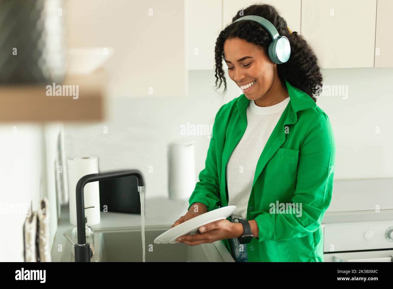Black Lady Doing Dishes Wearing Headphones Listening Music In Kitchen Stock Photo Alamy