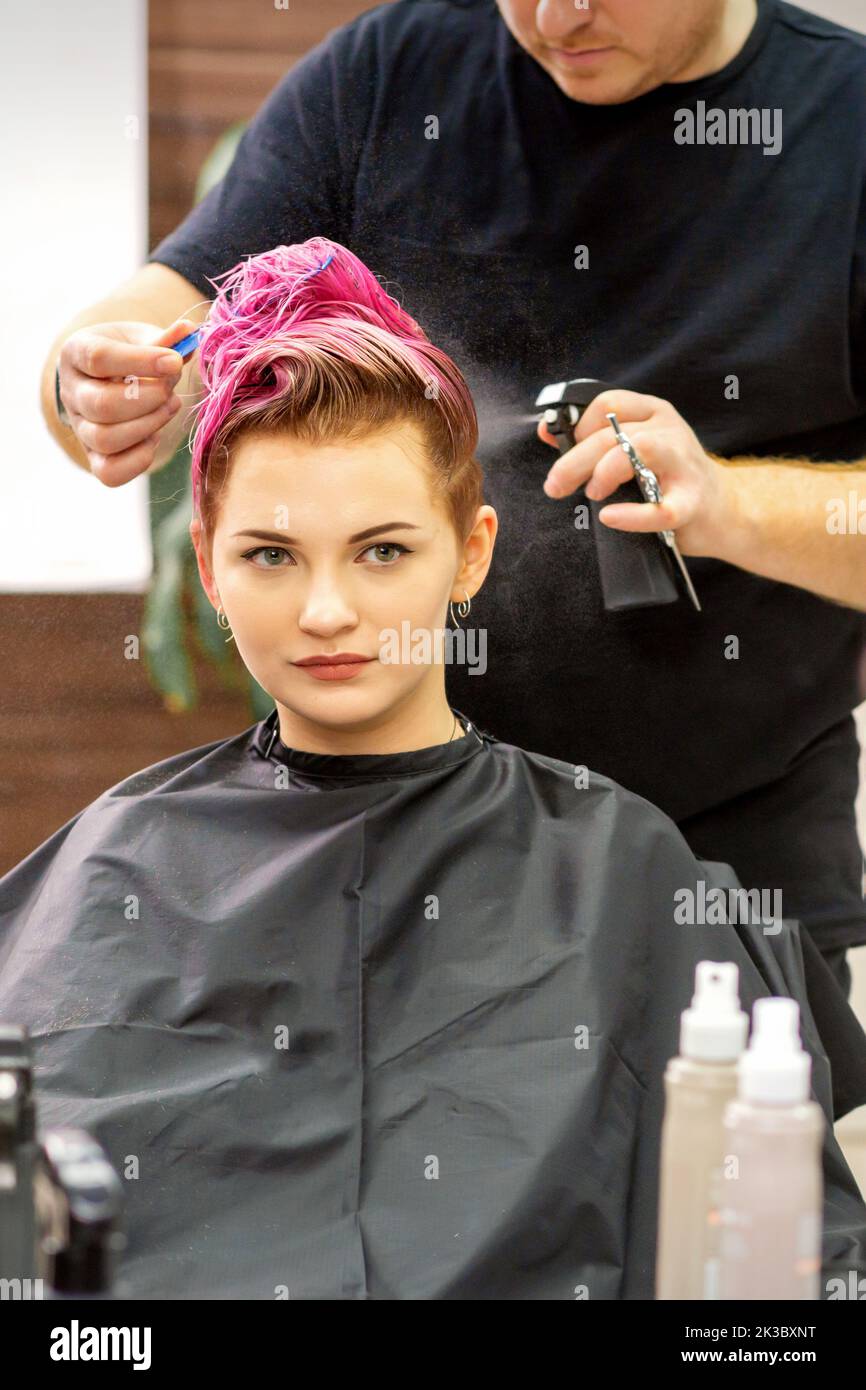 Beautiful young pink haired caucasian woman in the modern hair salon