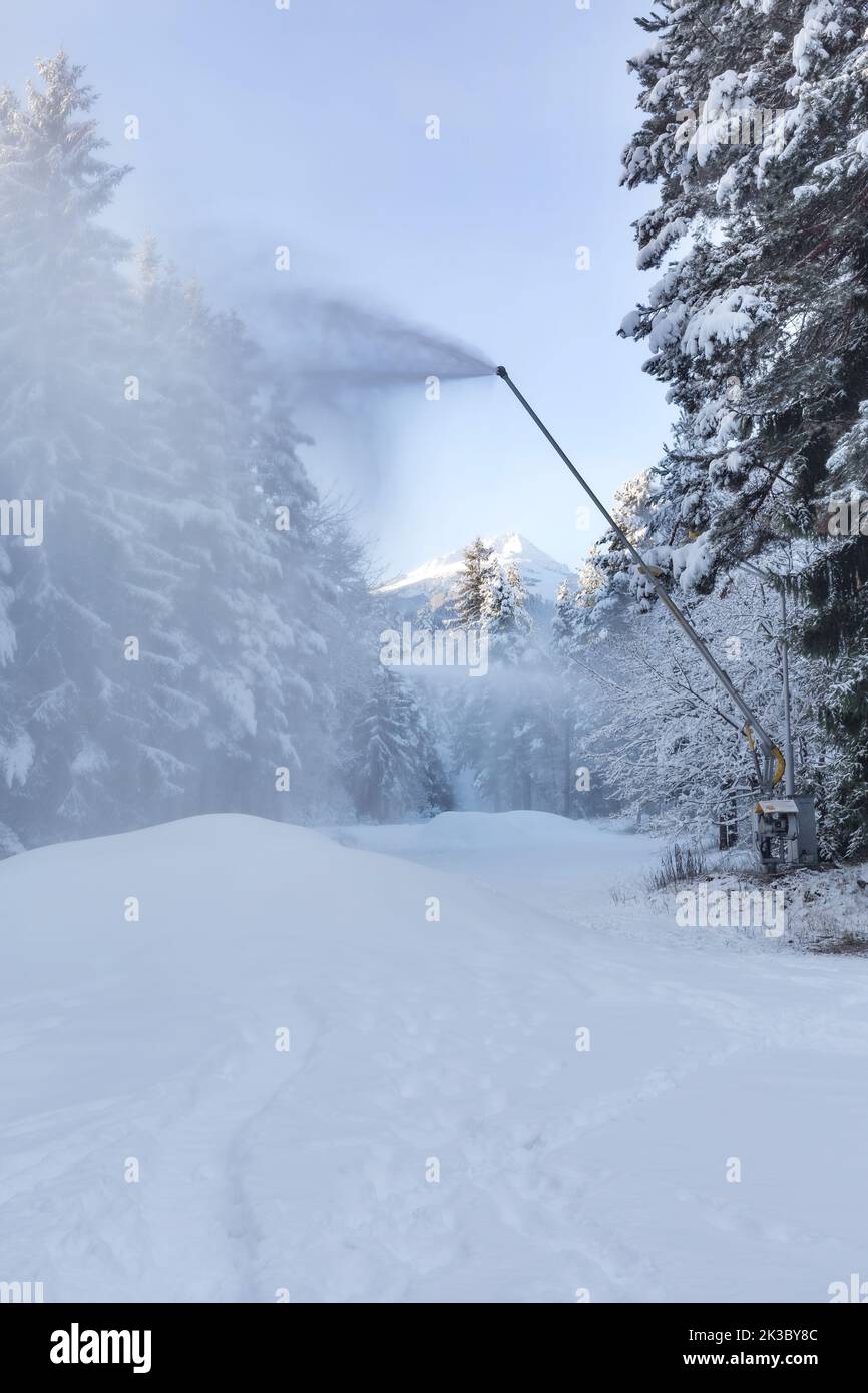 Snow gun machine waiting for frost with sun flare background, snowmaker  machine. Color effect Stock Photo - Alamy