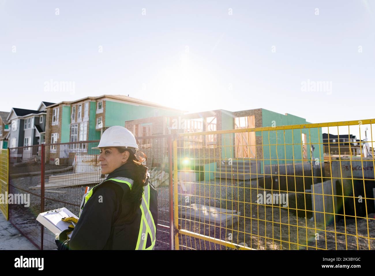 Female construction worker at sunny housing development Stock Photo Alamy