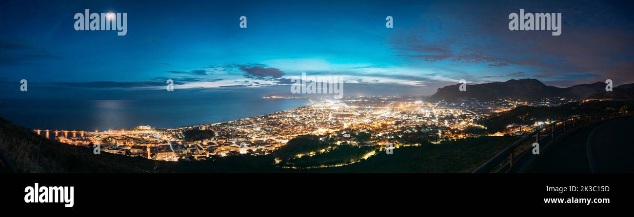 Terracina, Italy. Top View Skyline Cityscape City In Evening Night Illuminations. Panorama, Panoramic View Stock Photo