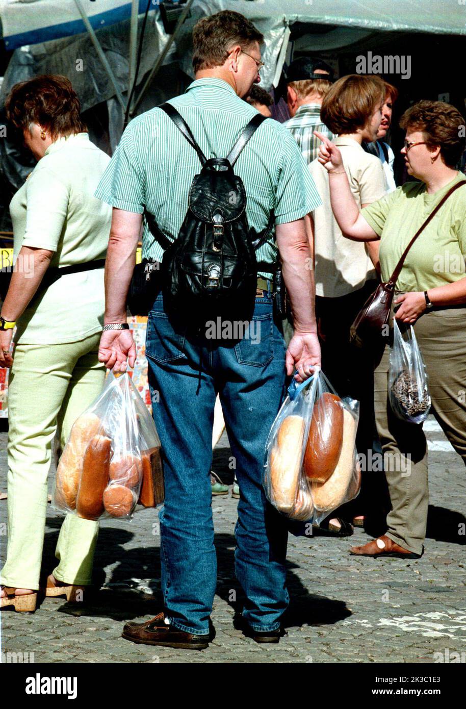 A man who bought fresh bread at a market place (Skänningemarken), Skänninge, Sweden Stock Photo