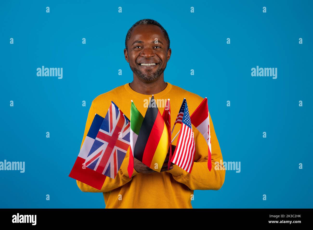 Middle-aged african american man holding various flags Stock Photo