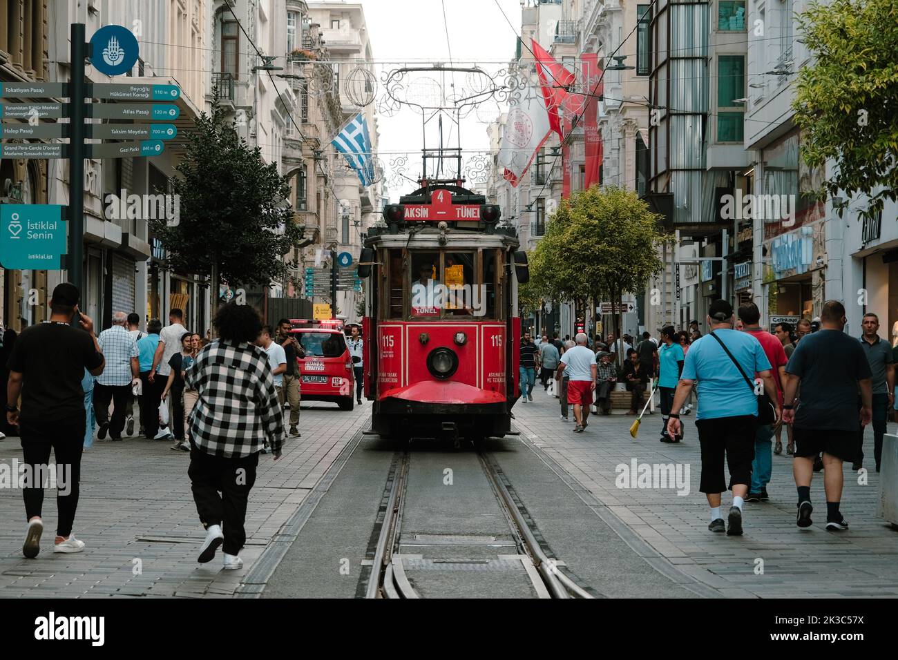 Front view of red tram in Istiklal street, cityscape in Istanbul, footage of popular red tram, retro street with walking people, old train Stock Photo