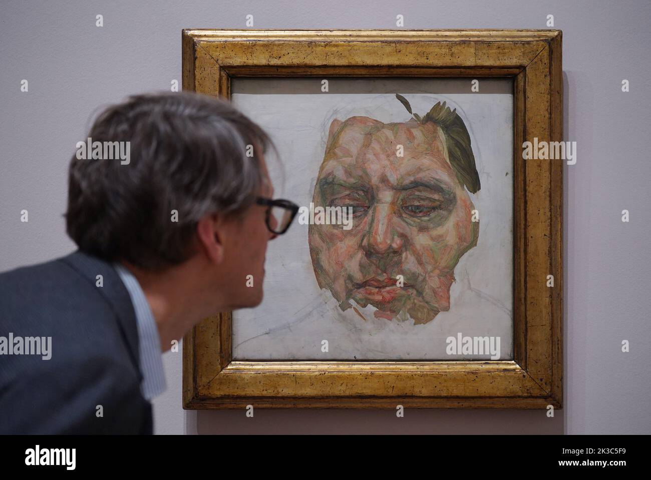 A gallery staff member poses next to a painting by Lucian Freud - Francis Bacon (Unfinished), 1956-7 - on show at a photocall for the Credit Suisse exhibition - Lucian Freud: New Perspectives at the National Gallery in London. Picture date: Monday September 26, 2022. Stock Photo