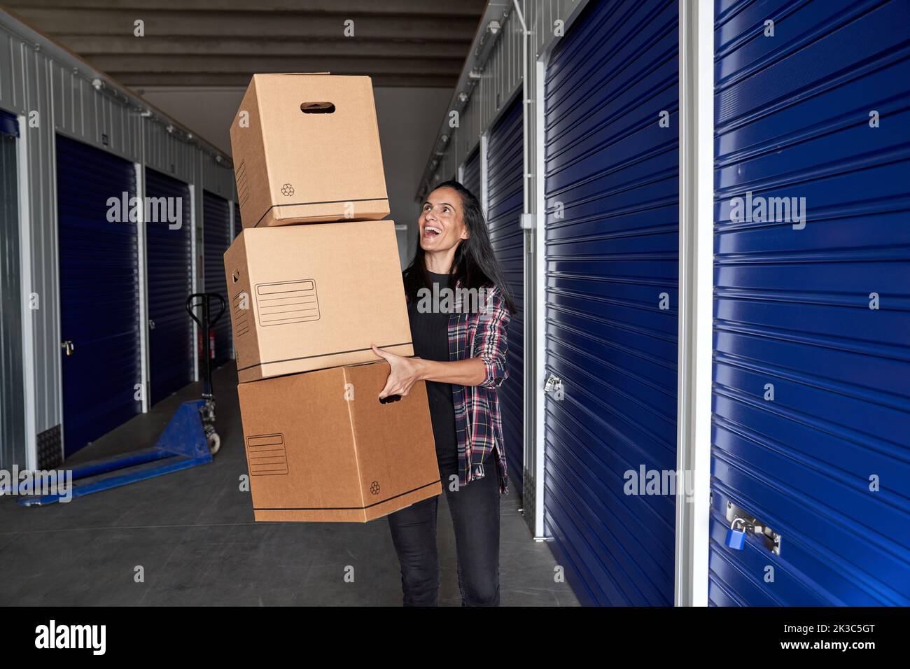 Woman carrying stack of cardboard boxes hi-res stock photography and ...