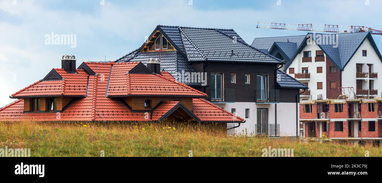 Construction site of apartment buildings at Zlatibor in Serbia. Modern built structure with scaffolding in popular serbian tourist resort. Stock Photo