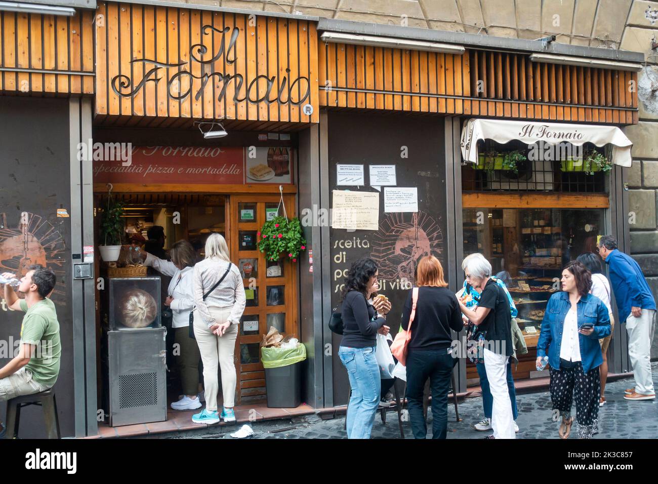 Rome, Italy - September 2022 - People eating outside bakery Il Fornaio Stock Photo