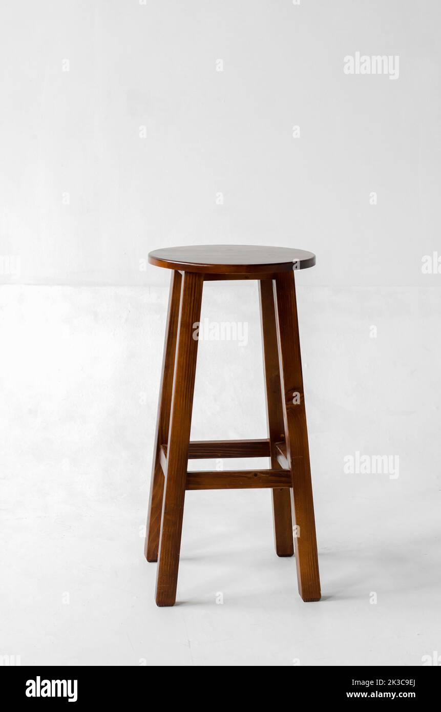 Brown wooden stool with four legs on a white background Stock Photo - Alamy