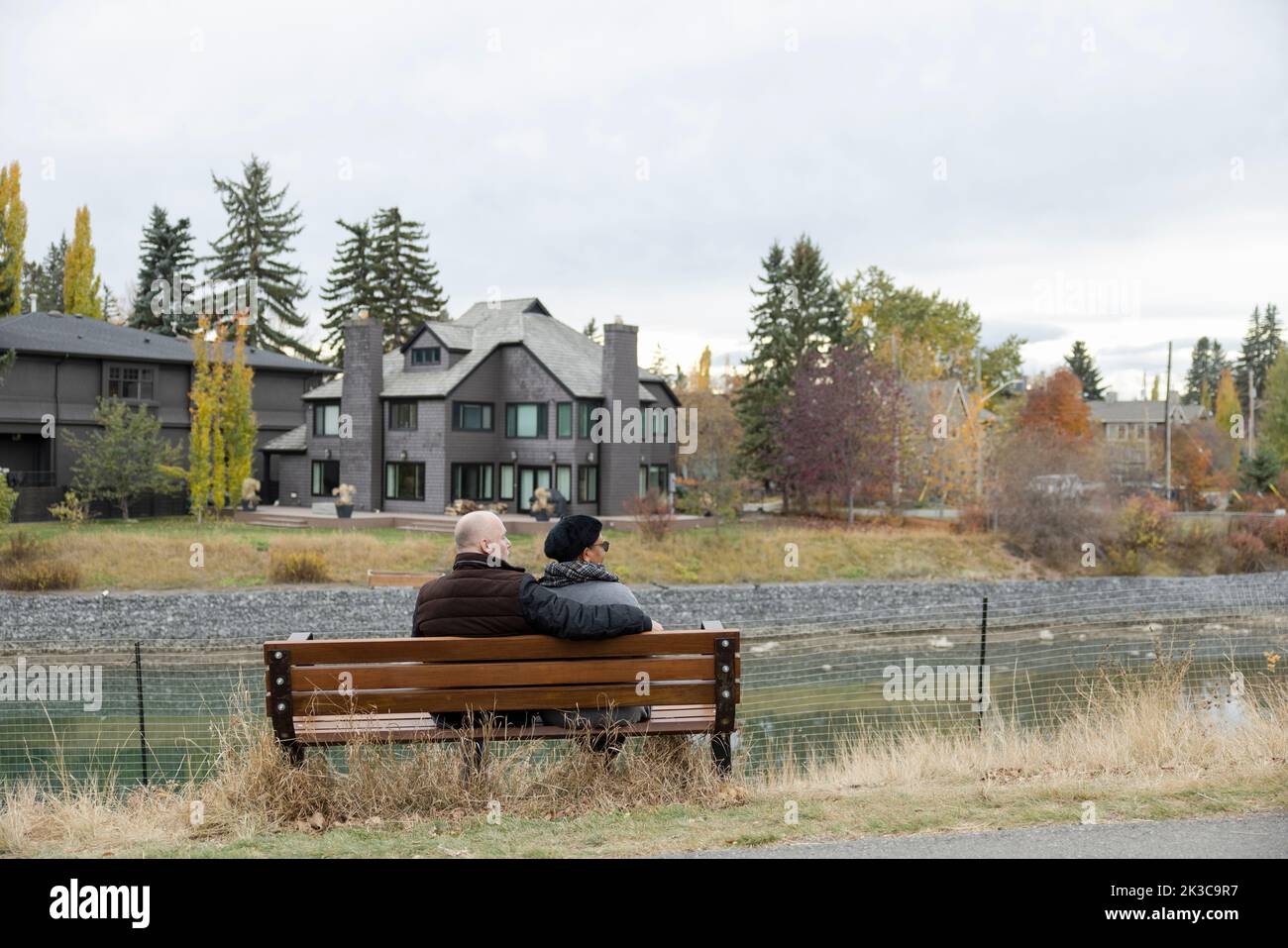 Mature couple on suburban park bench Stock Photo