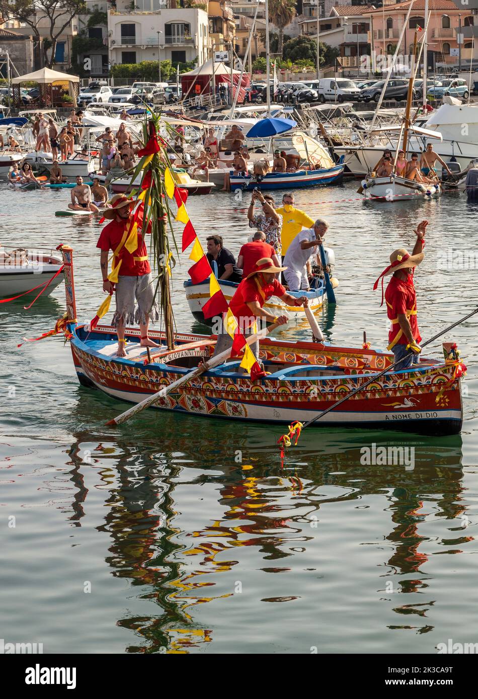 The annual festival of 'U Pisci a Mari' in the Sicilian village of Aci Trezza, near Catania. This takes place around the Feast of the Nativity of St John the Baptist, at the end of June. It represents a traditional fishing expedition for swordfish, which used to take place in the Strait of Messina. The part of the swordfish is played by a swimmer, who is repeatedly caught by the fishermen, bloodily sliced up but then somehow manages to escape. Eventually the 'swordfish' manages to overturn the boat. Stock Photo