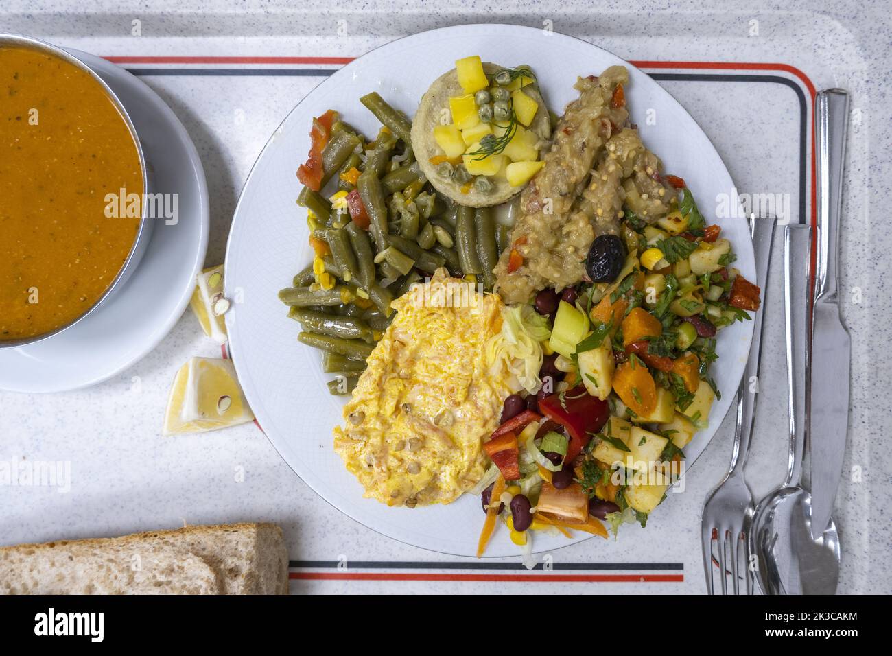 Top view of vegan food plate with soup, many colorful vegetable foods