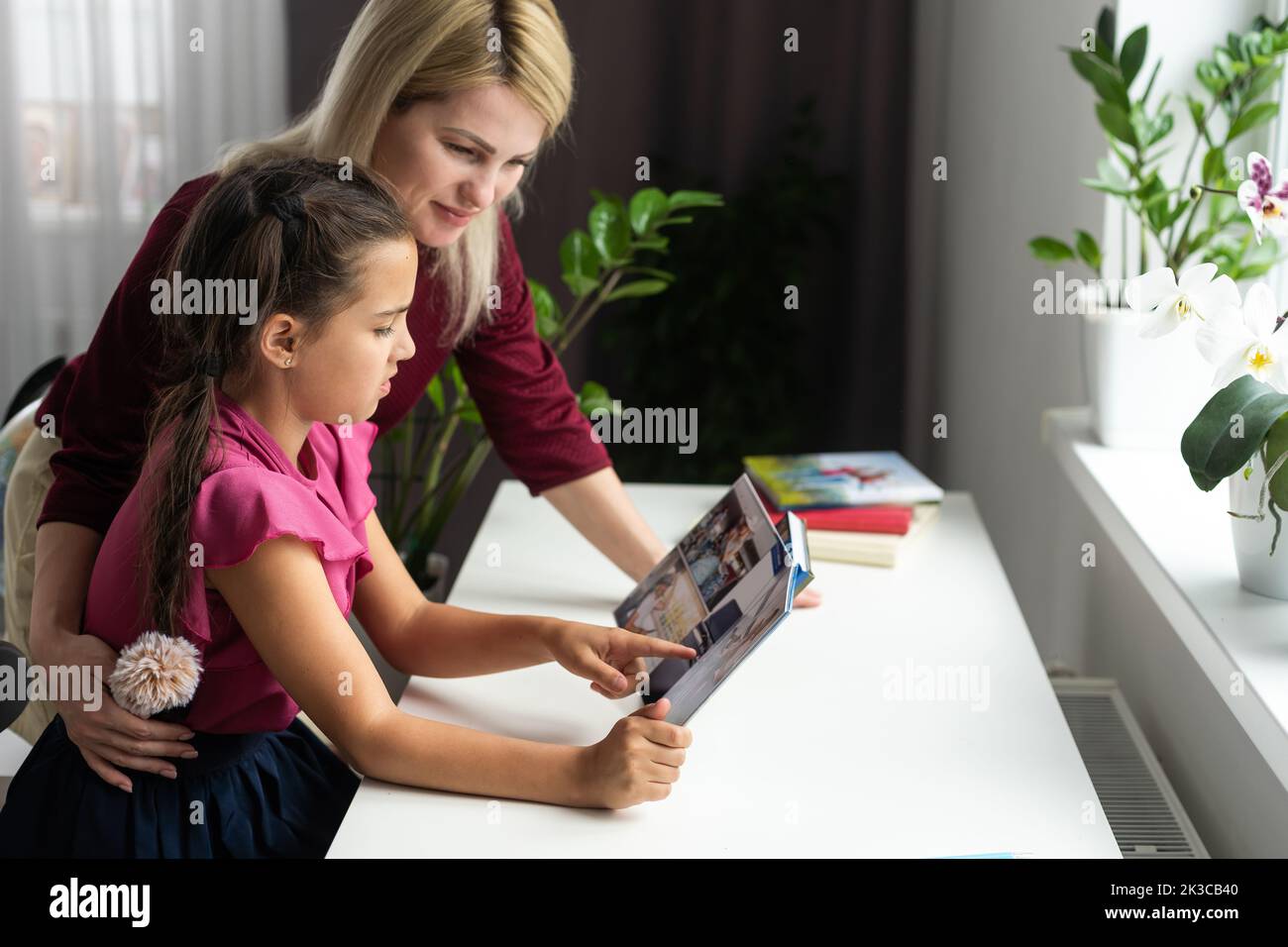 Mother And Daughter Looking Photo Book At Home Stock Photo Alamy mother-and-daughter-looking-photo-book-at-home-stock-photo-alamy