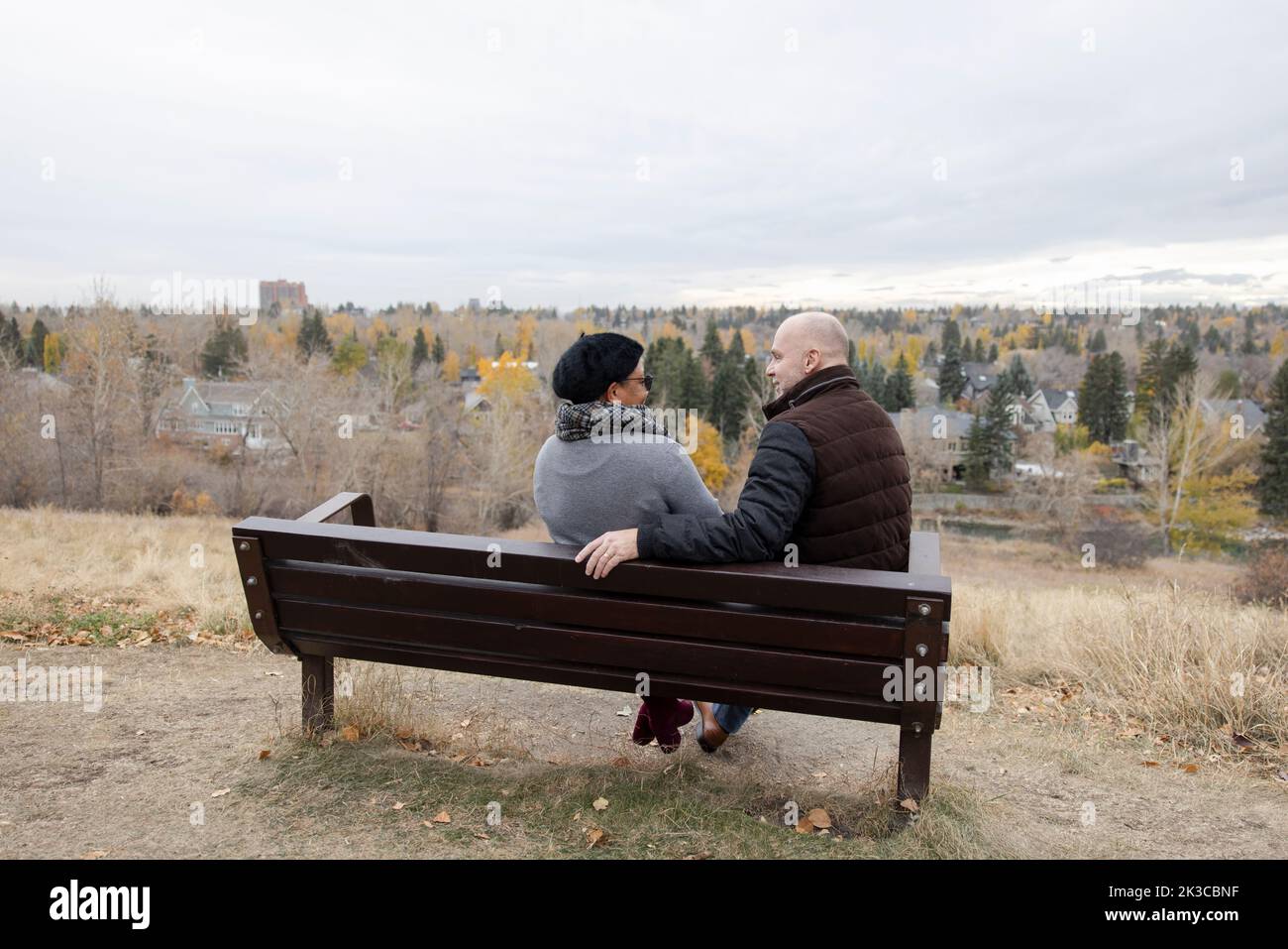Mature couple talking on autumn park bench Stock Photo - Alamy