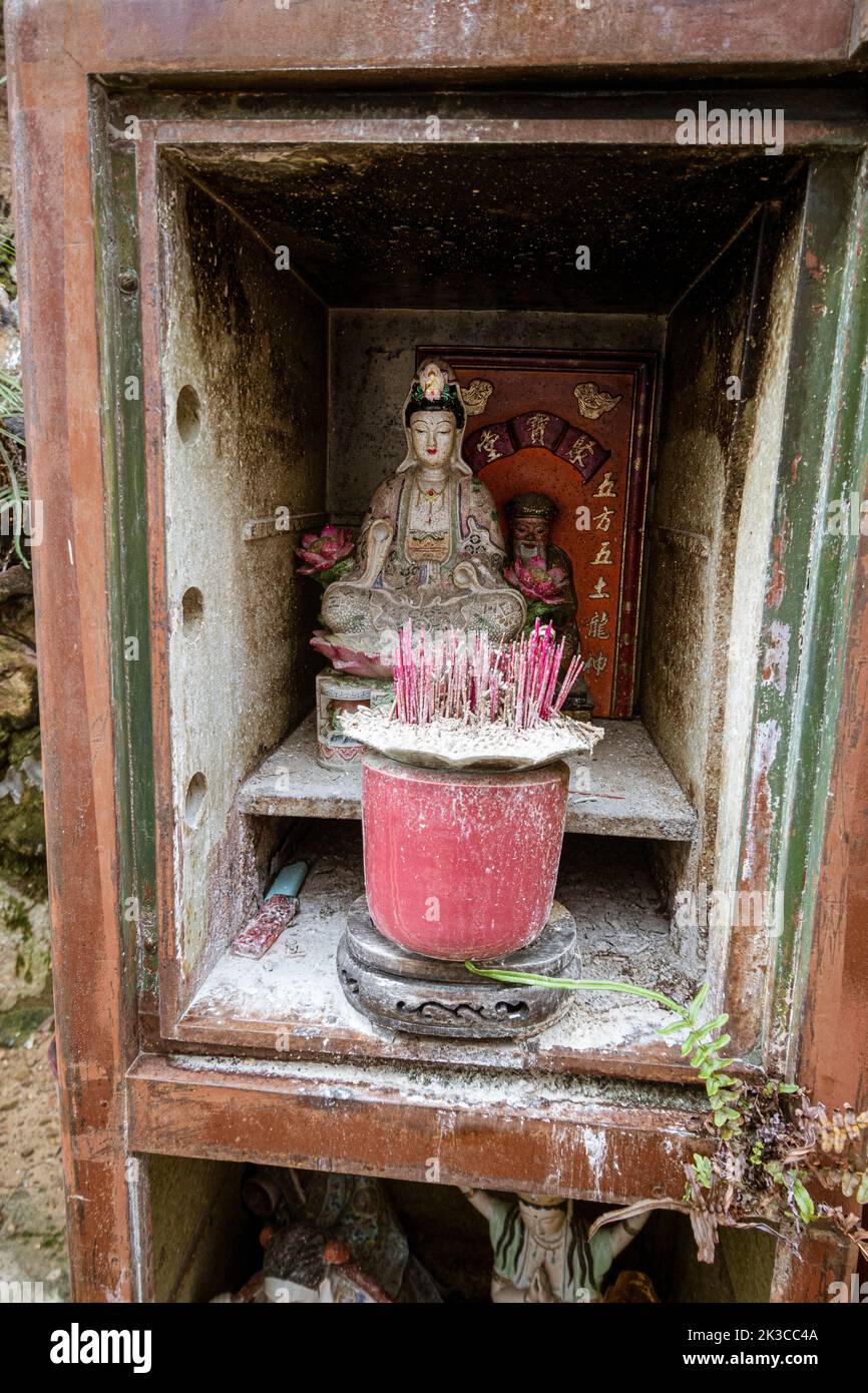 Singapore, July 24, 2022 Roadside prayer alter with burned candles