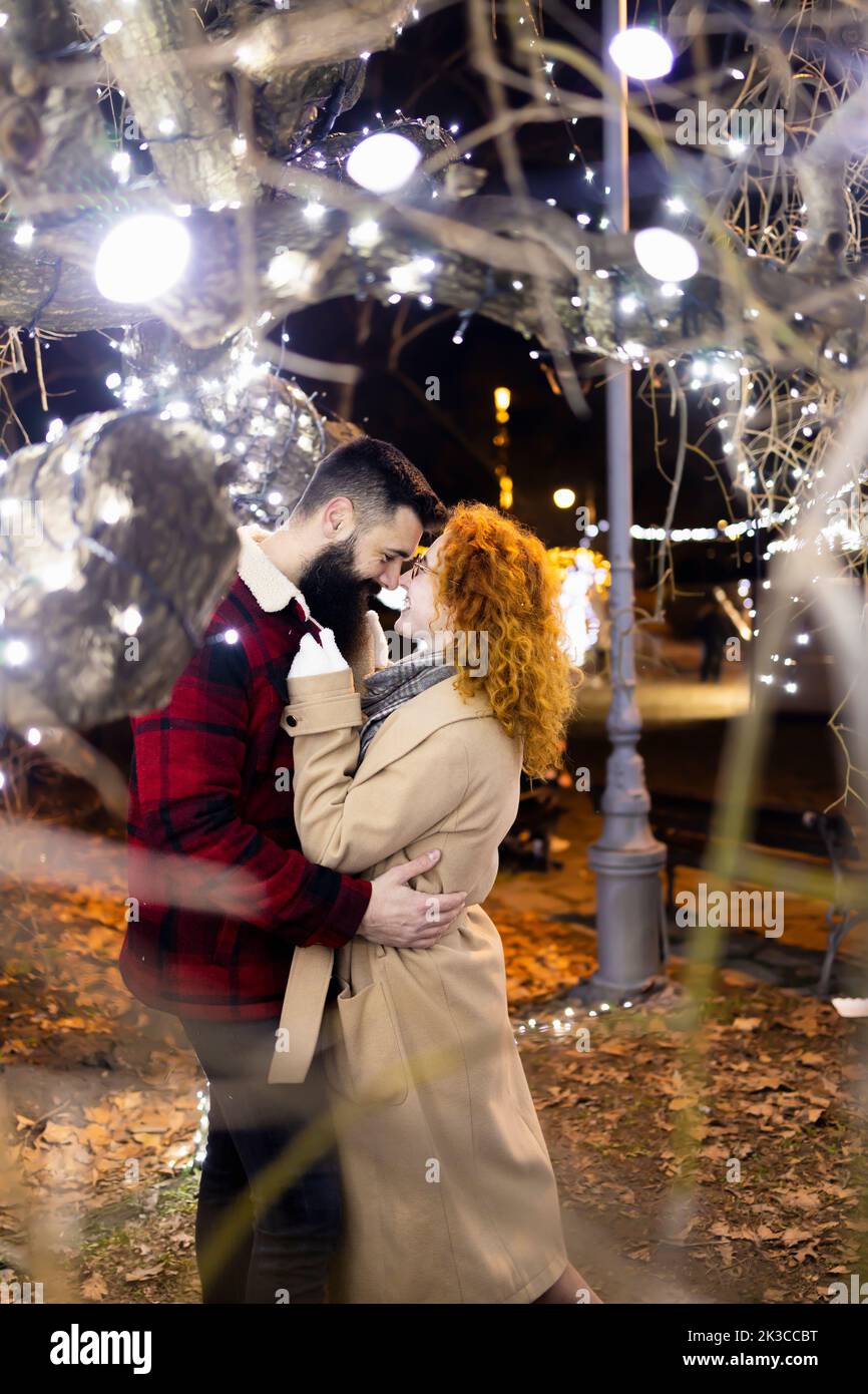 A couple holding each other on a beautiful Christmas eve Stock Photo