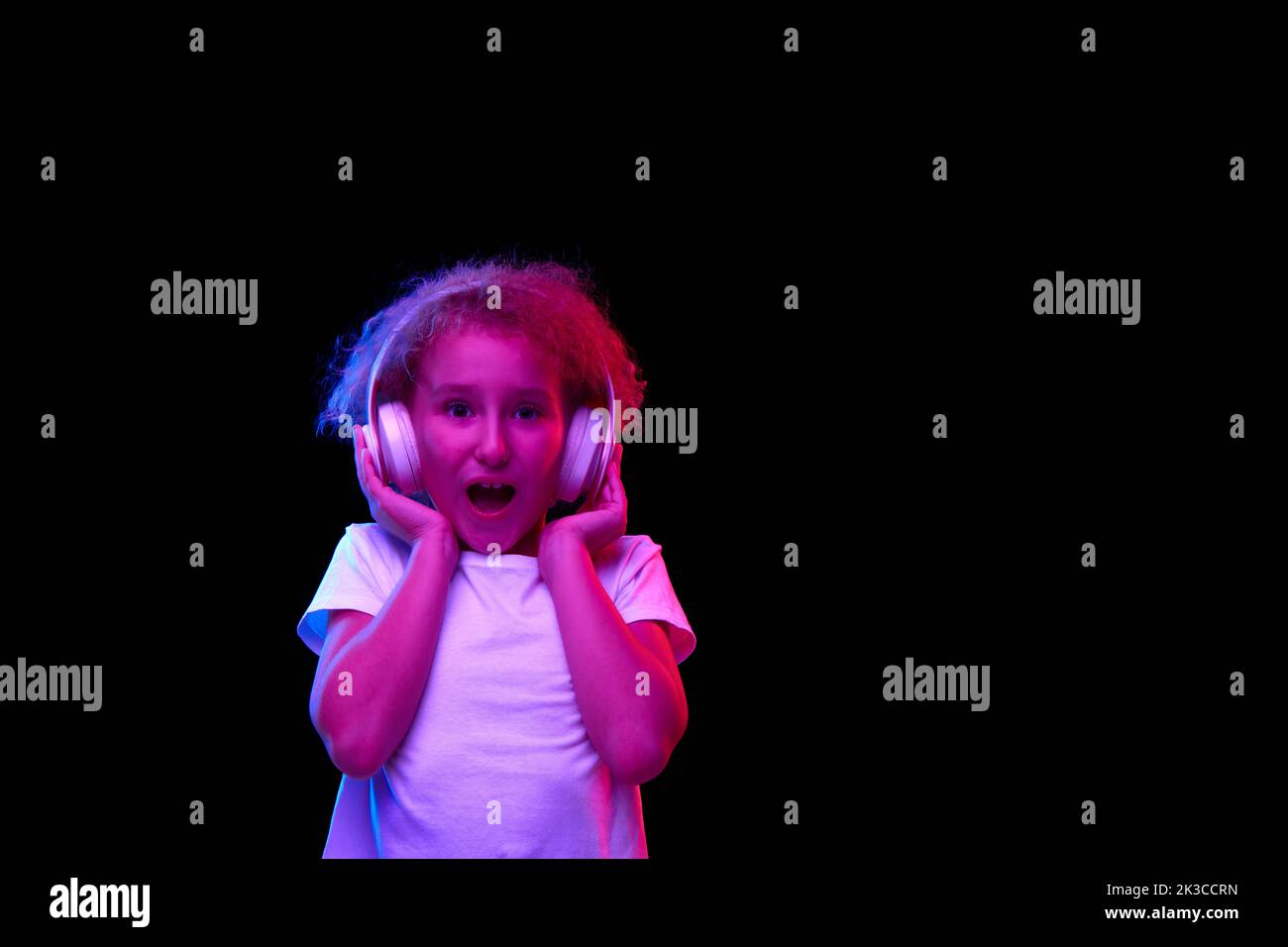 Little Shocked Girl 6 7 Years Old Wearing White T Shirt And Headphones