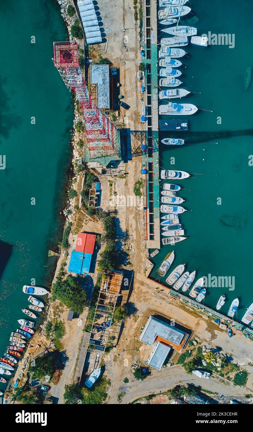 Aerial view of amazing boats at sunset. Top view from the drone of the port with yacht, speedboat and sailboat in Caraballeda, La Guaira, Venezuela. Stock Photo
