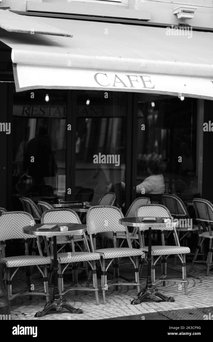 Paris, France. Outdoor Cafe, Restaurant Terrace Tables with Wicker Chairs. Classic French Cafe View. Stock Photo