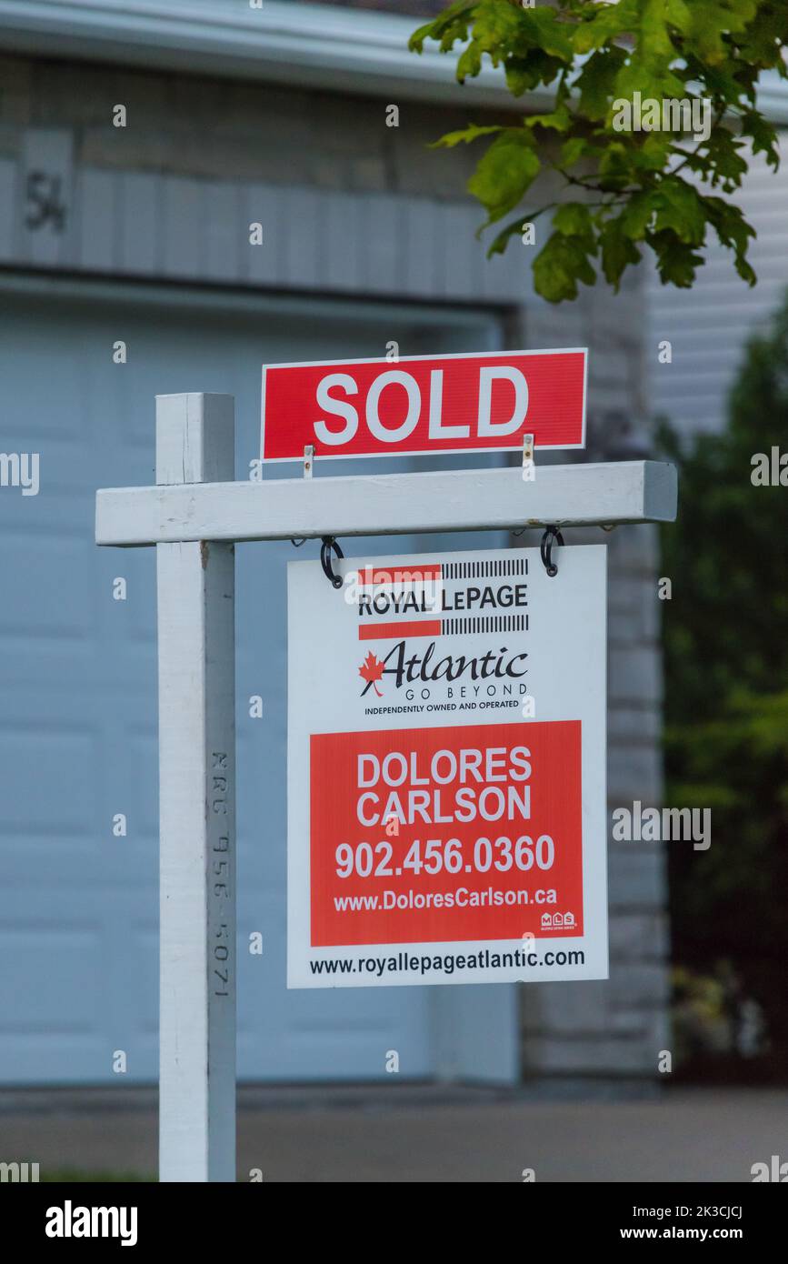 Estate agency SOLD sign with name of Agencyu. Real estate market property sold sign in front of new house. HALIFAX, NOVA SCOTIA - AUG 2022 Stock Photo