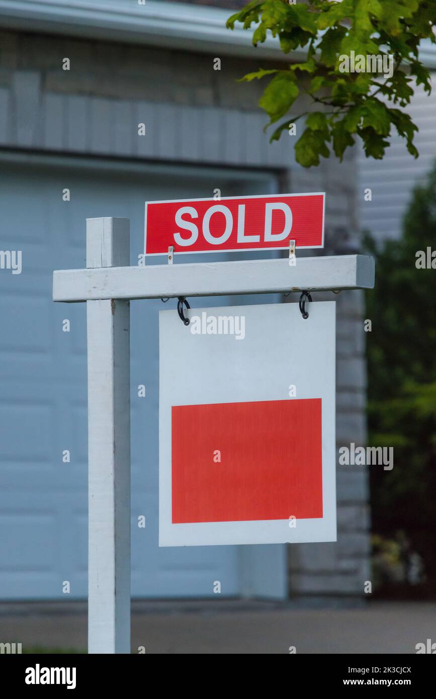 Real state agency SOLD sign. Real estate market property sold sign in front of new house. Copy space for Text. Stock Photo
