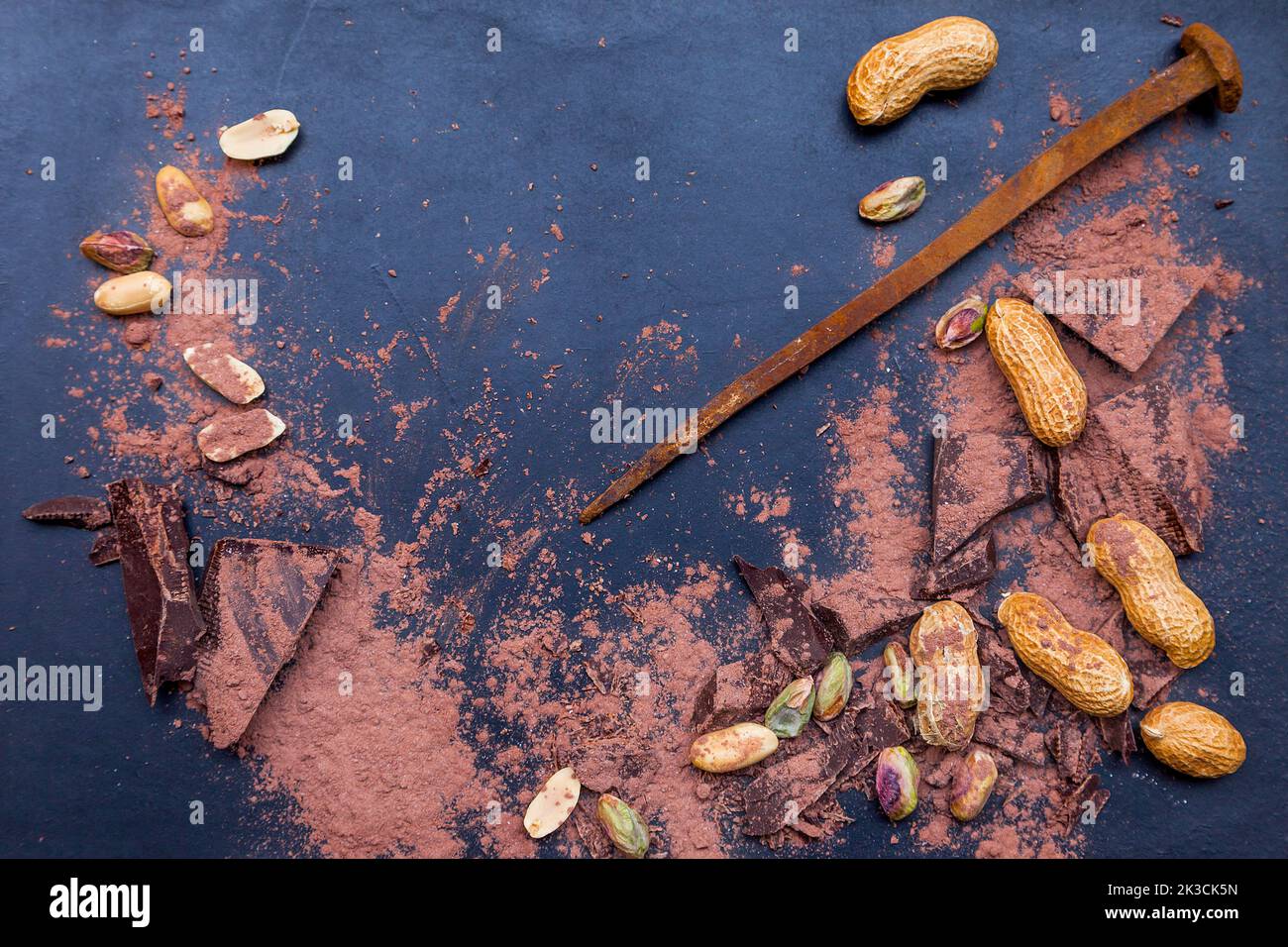 dark chocolate pieces mixed with cocoa powder on blackboard background ...