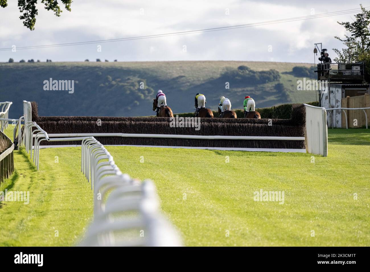 Jockeys ride up the hill at Plumpton racecourse Stock Photo Alamy