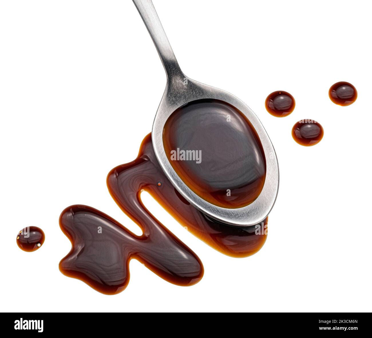 Balsamic sauce in spoon isolated on white background, top view Stock Photo