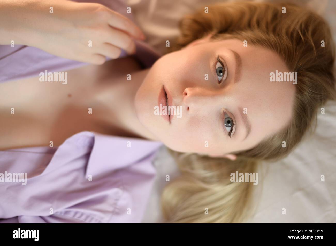 Portrait of a young woman with blue eyes. Top view. Stock Photo