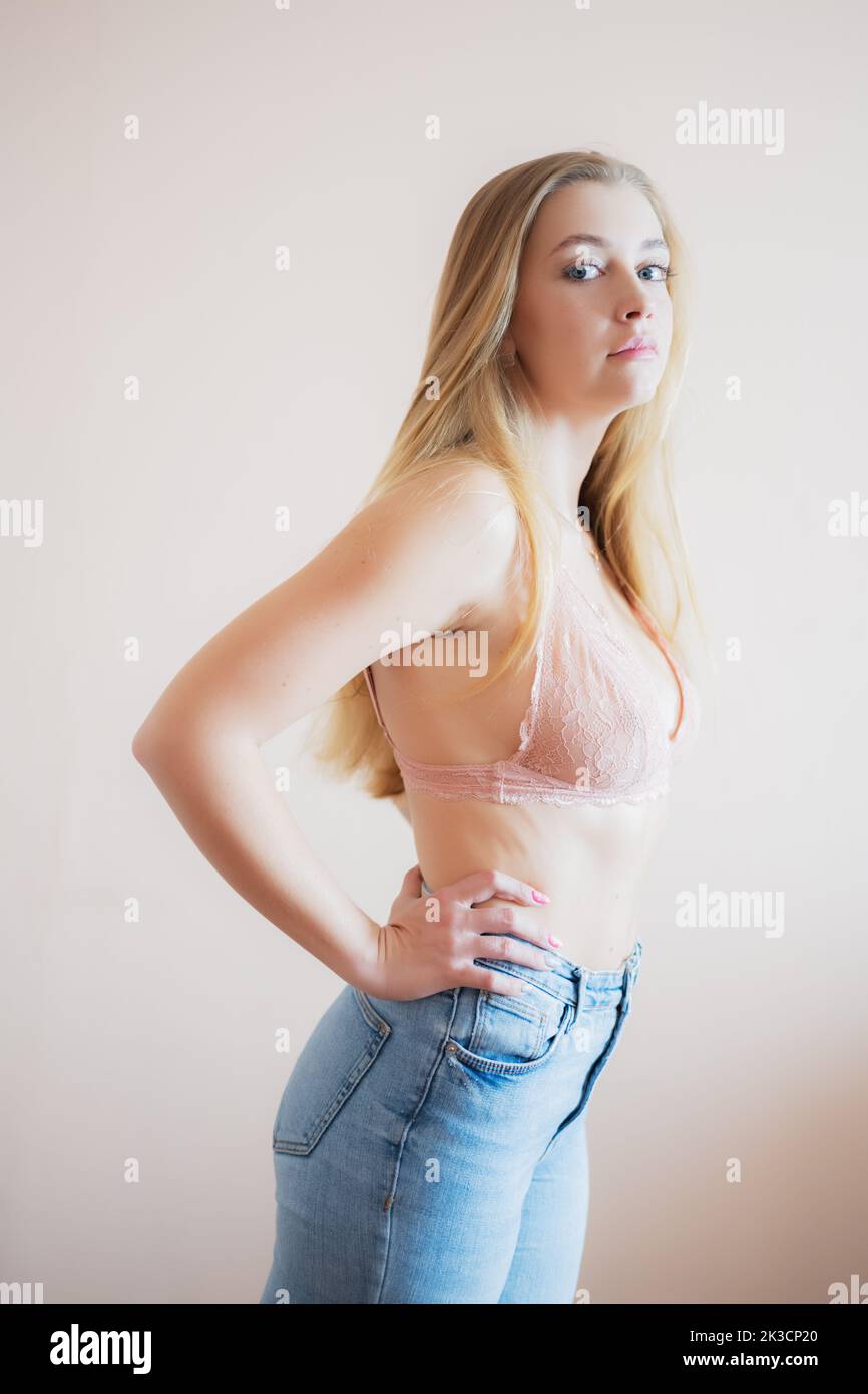 Young beautiful woman wearing pink top lingerie with denim short pants in  studio lighting Stock Photo