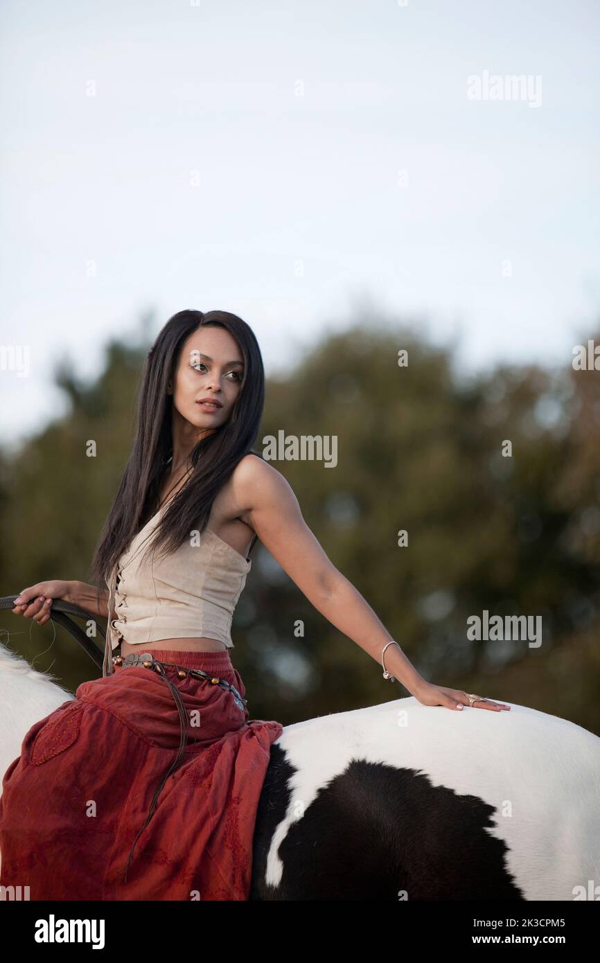 Interpretation of a 19th Century gypsy girl on horseback Stock Photo