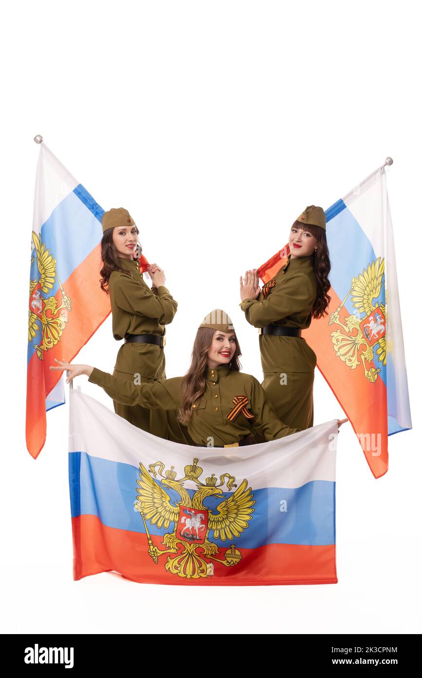 Smiling women in military uniforms with Russian flags Stock Photo