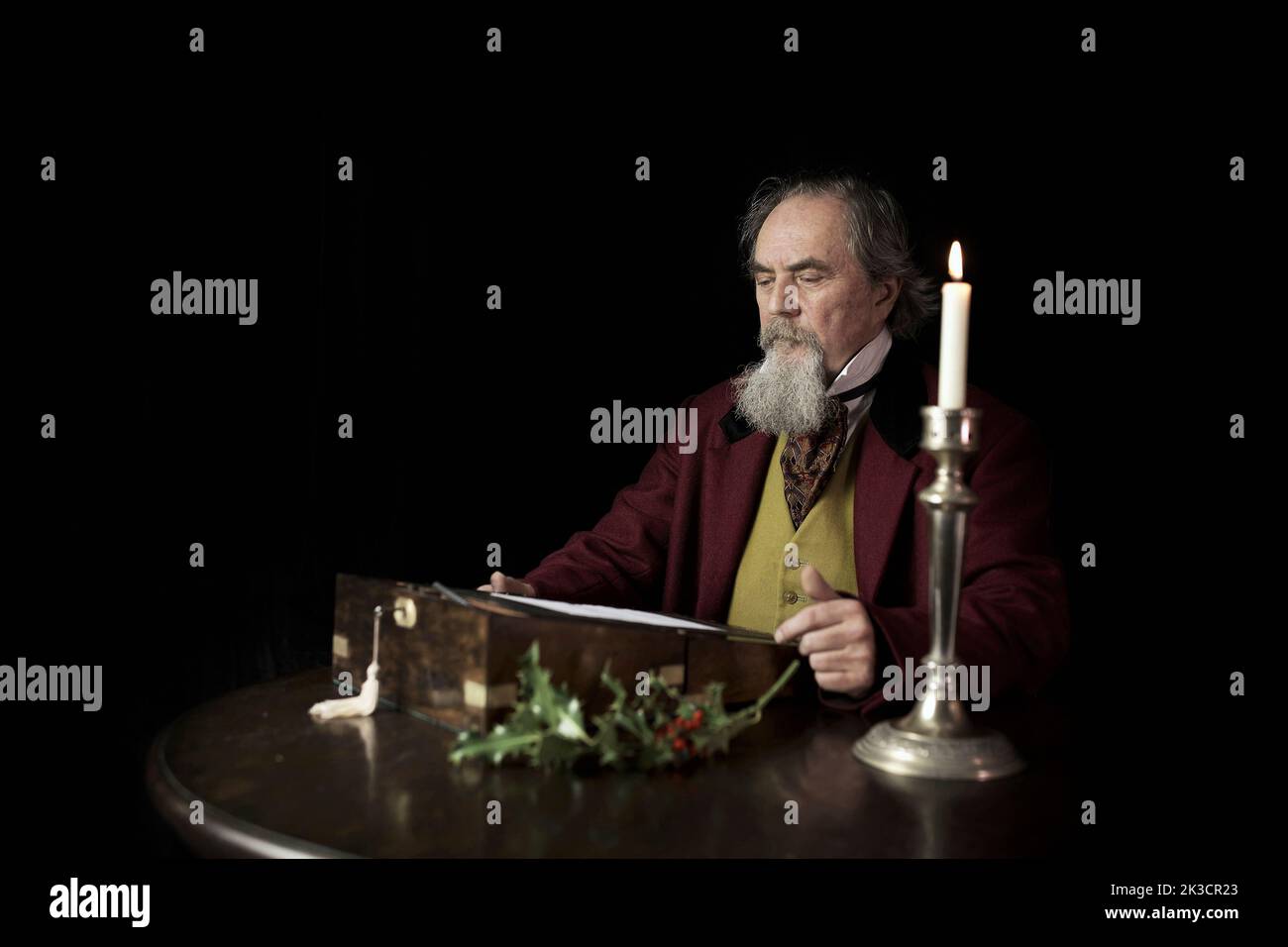 Interpretation of the 19th Century Classic British novelist Charles Dickens writing A Christmas Carol. Stock Photo