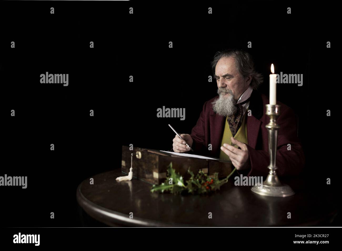 Interpretation of the 19th Century Classic British novelist Charles Dickens writing A Christmas Carol. Stock Photo
