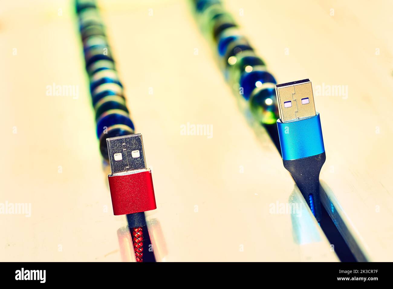 Connect and chat. Blue and red usb cables and colored balloons Stock Photo