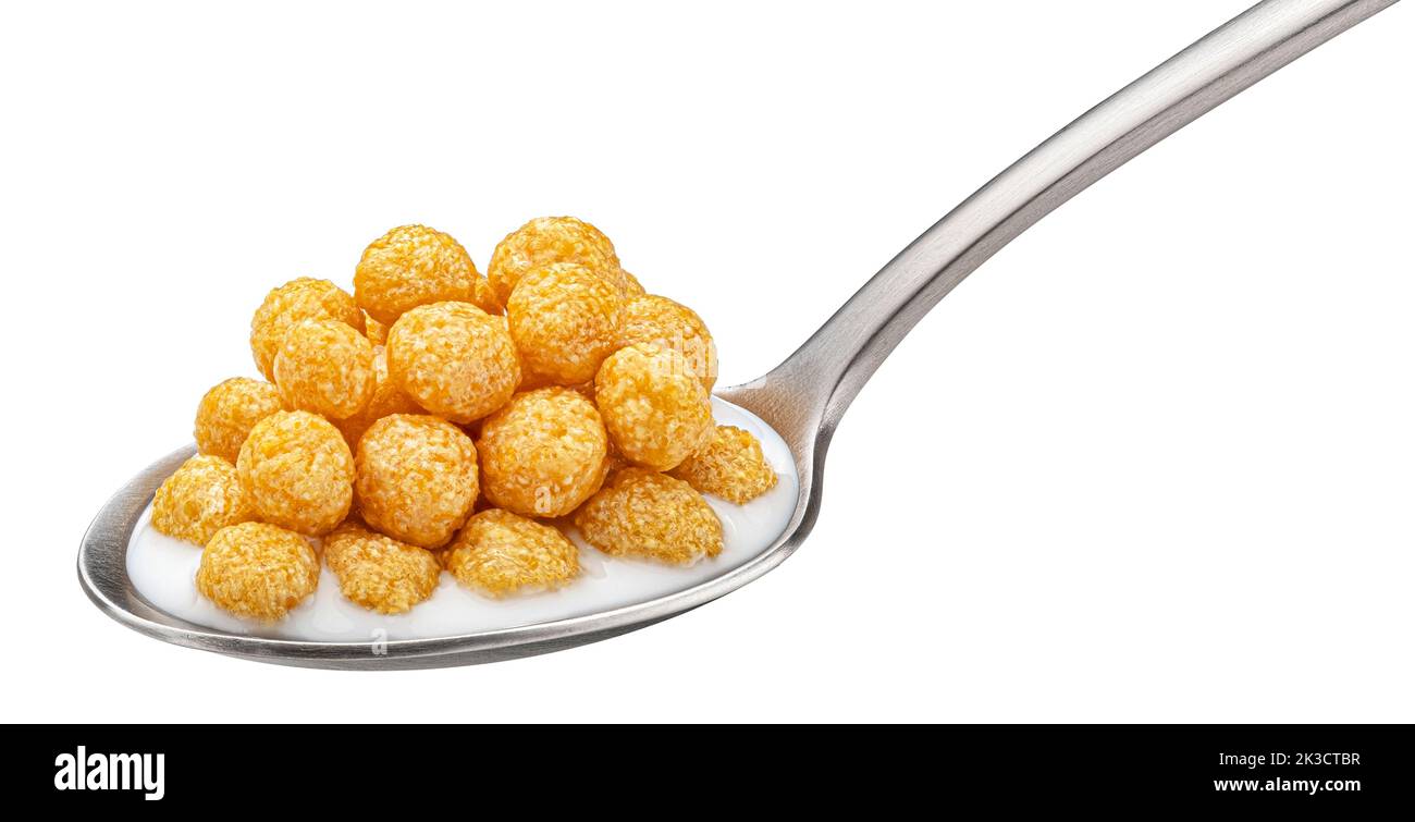 Corn balls with milk in spoon isolated on white background Stock Photo
