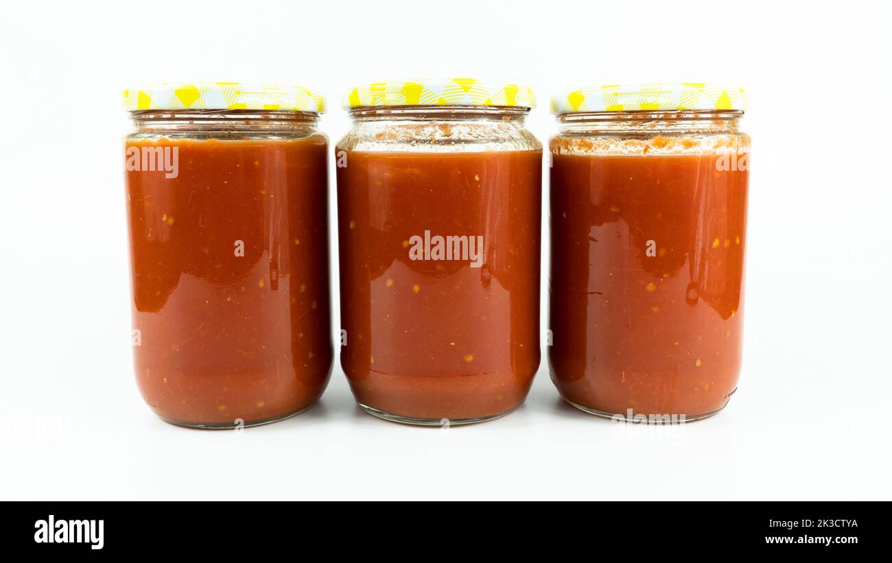 Tomato sauce in a jar. Homemade tomato sauce making process concept
