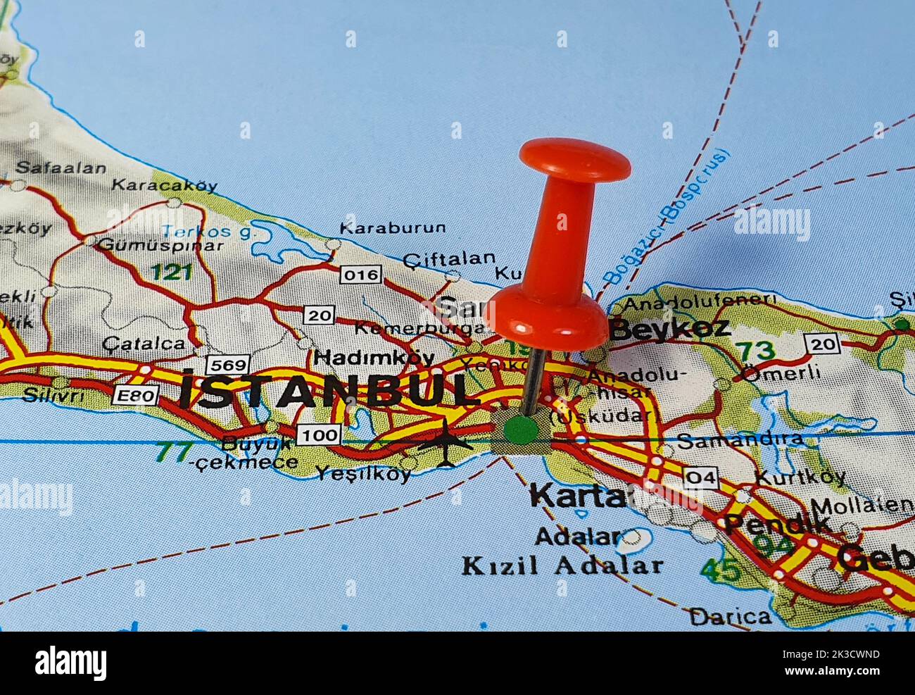 A closeup of a red pin placed on the city of Istanbul on a paper map Stock Photo