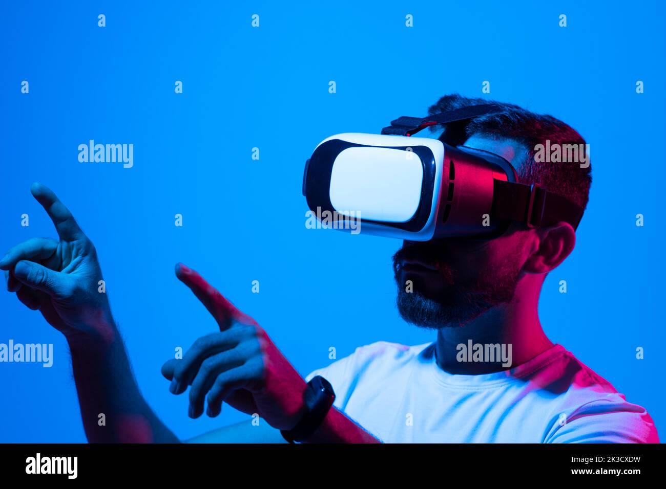Man's portrait of bearded man wearing virtual reality glasses. Handsome caucasian male using VR headset, playing video games. Playing with VR. Stock Photo