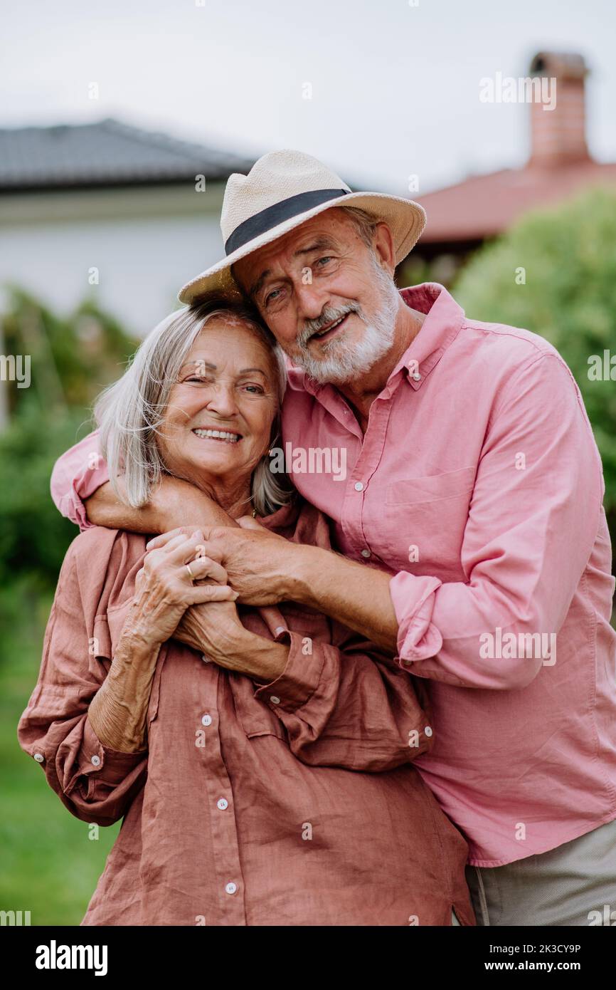 Senior couple in love posing together in their garden. Stock Photo