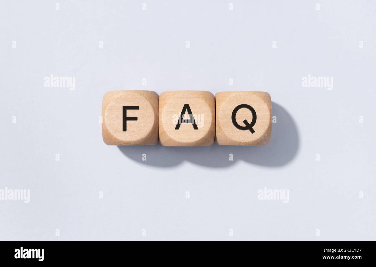 FAQ or Frequently Asked Questions concept. Text on Wooden cube blocks isolated on gray background Stock Photo