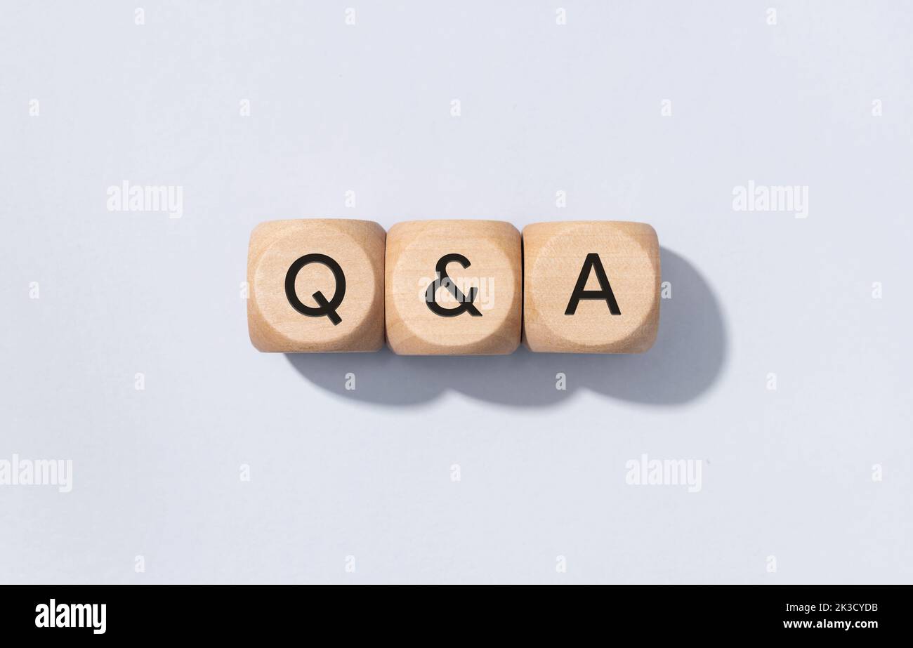 Q&A or questions and answers concept. Text on Wooden cube blocks isolated on gray background Stock Photo