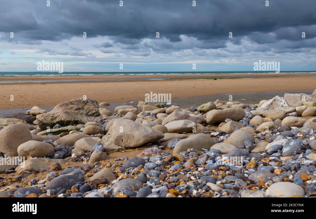 low tide on the french beach with lot of stones Stock Photo