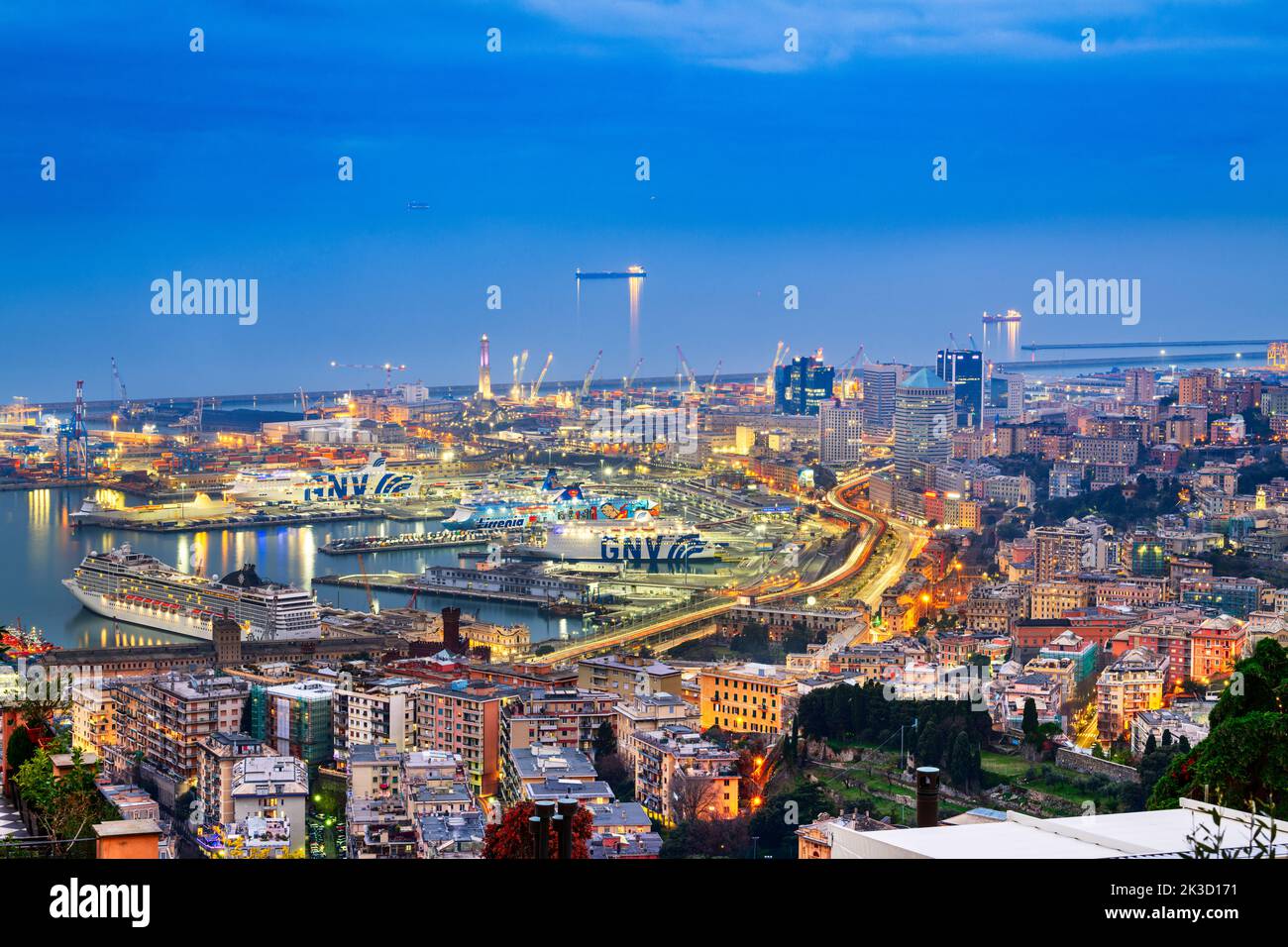 GENOA, ITALY - DECEMBER 31, 2021: Ferries and cargo ships wait in the Port of Genoa at dusk. With a trade volume of 51.6 million tonnes, it is one of Stock Photo